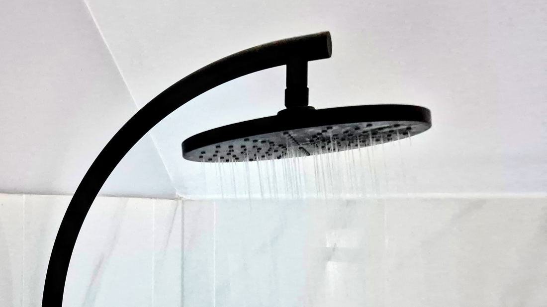 New matte black shower installed in a renovated bathroom