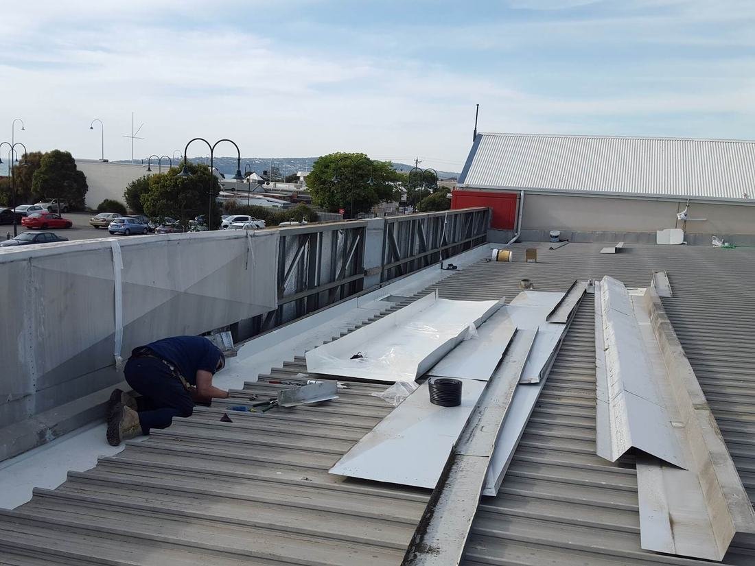 Box gutter replacement under way on a commercial roof