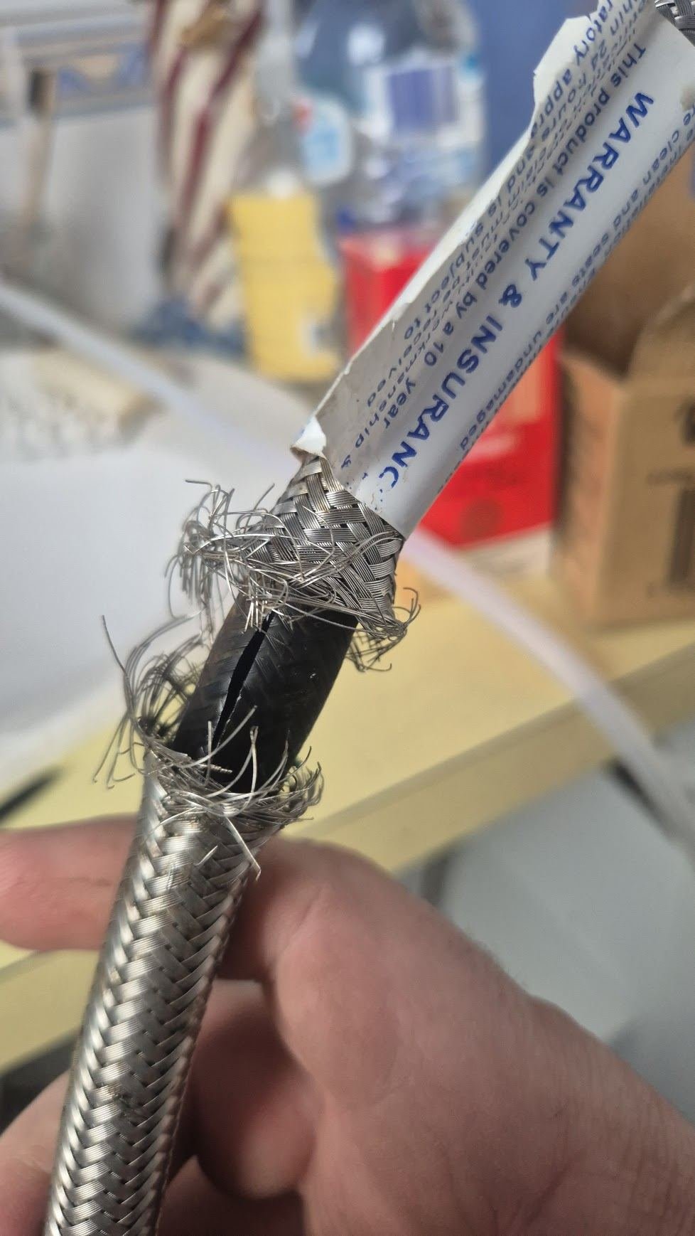 Failed braided flexi hose with frayed stainless braid