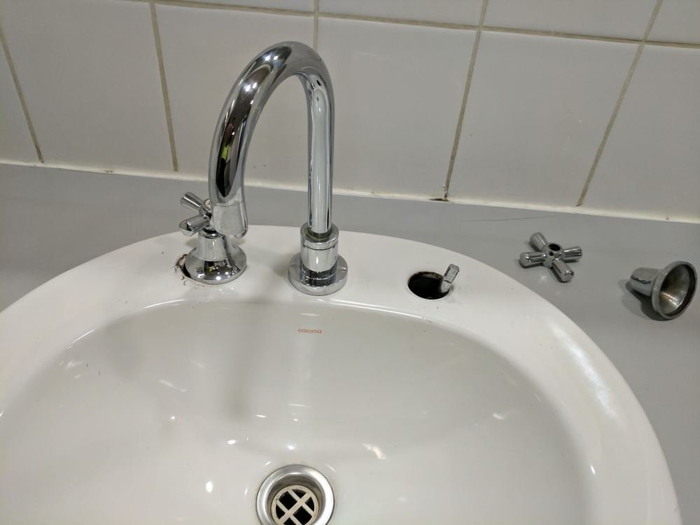 Basin tap dismantled for repair with new spindle parts