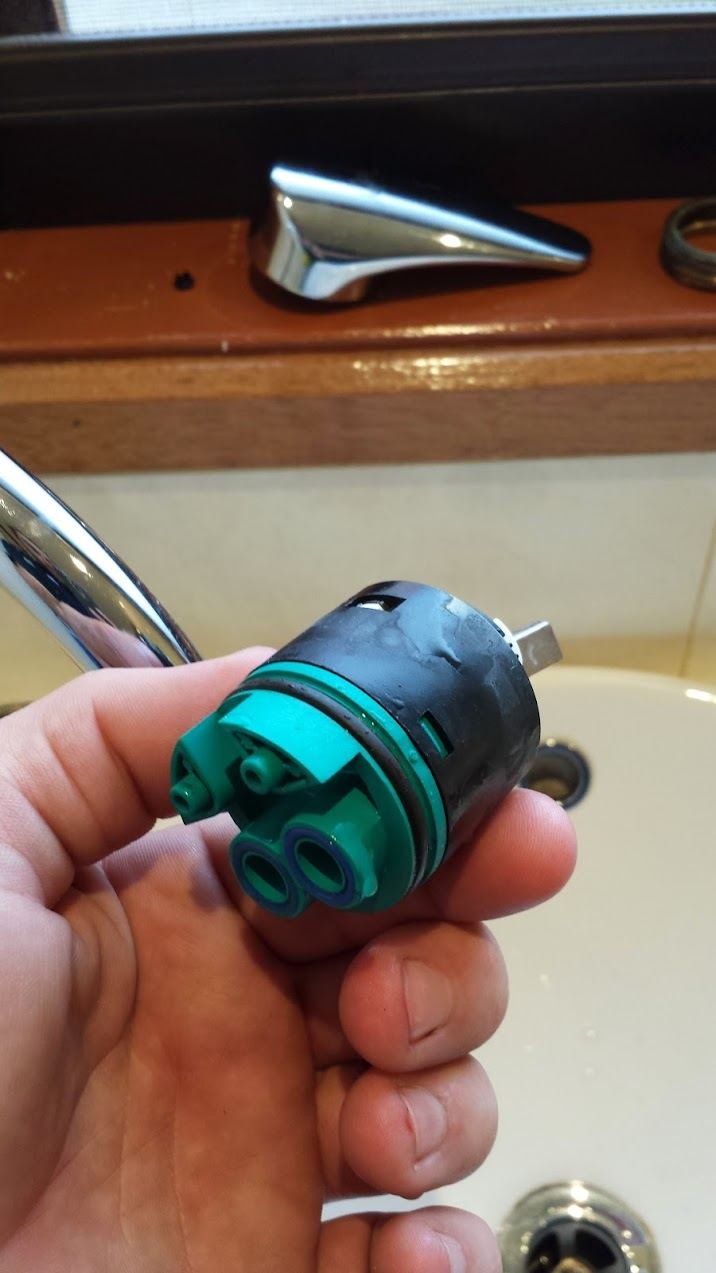 Worn mixer cartridge removed from a kitchen tap